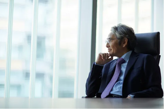 A senior executive looking out over the city from a corner office
