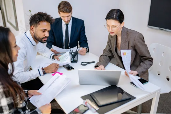 A product and architecture team reviewing plans together around a table